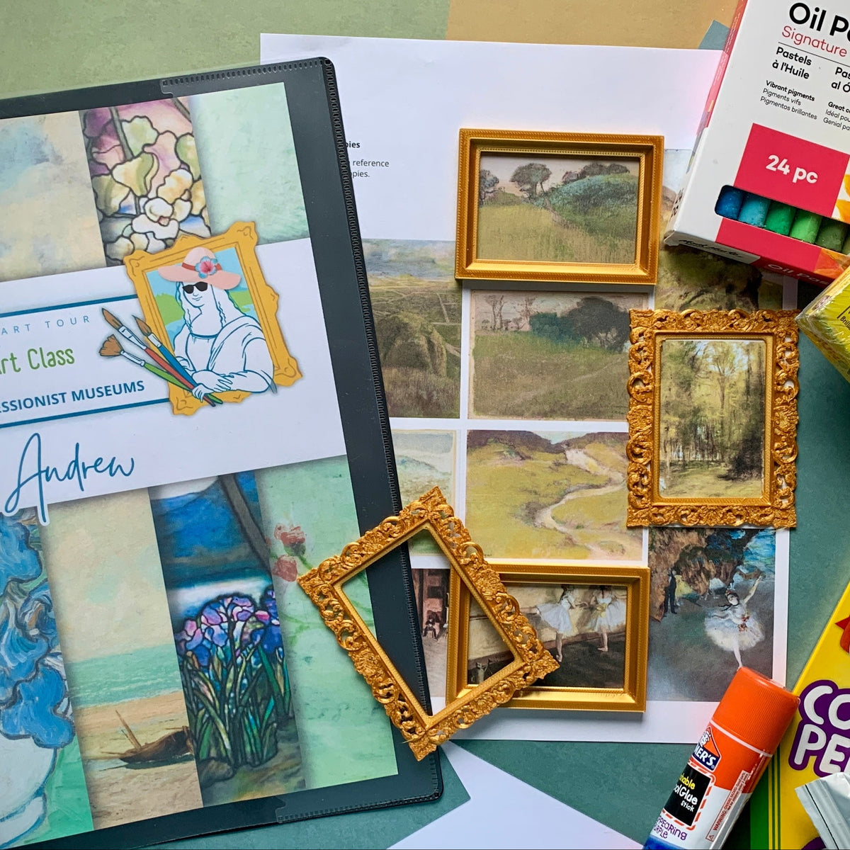A collage of art supplies and a mini impressionist art class kit laid out on a green surface, including a printed art class booklet, small gold picture frames, Crayola crayons, Pastel soft pastels, oil pastels, and a glue stick.